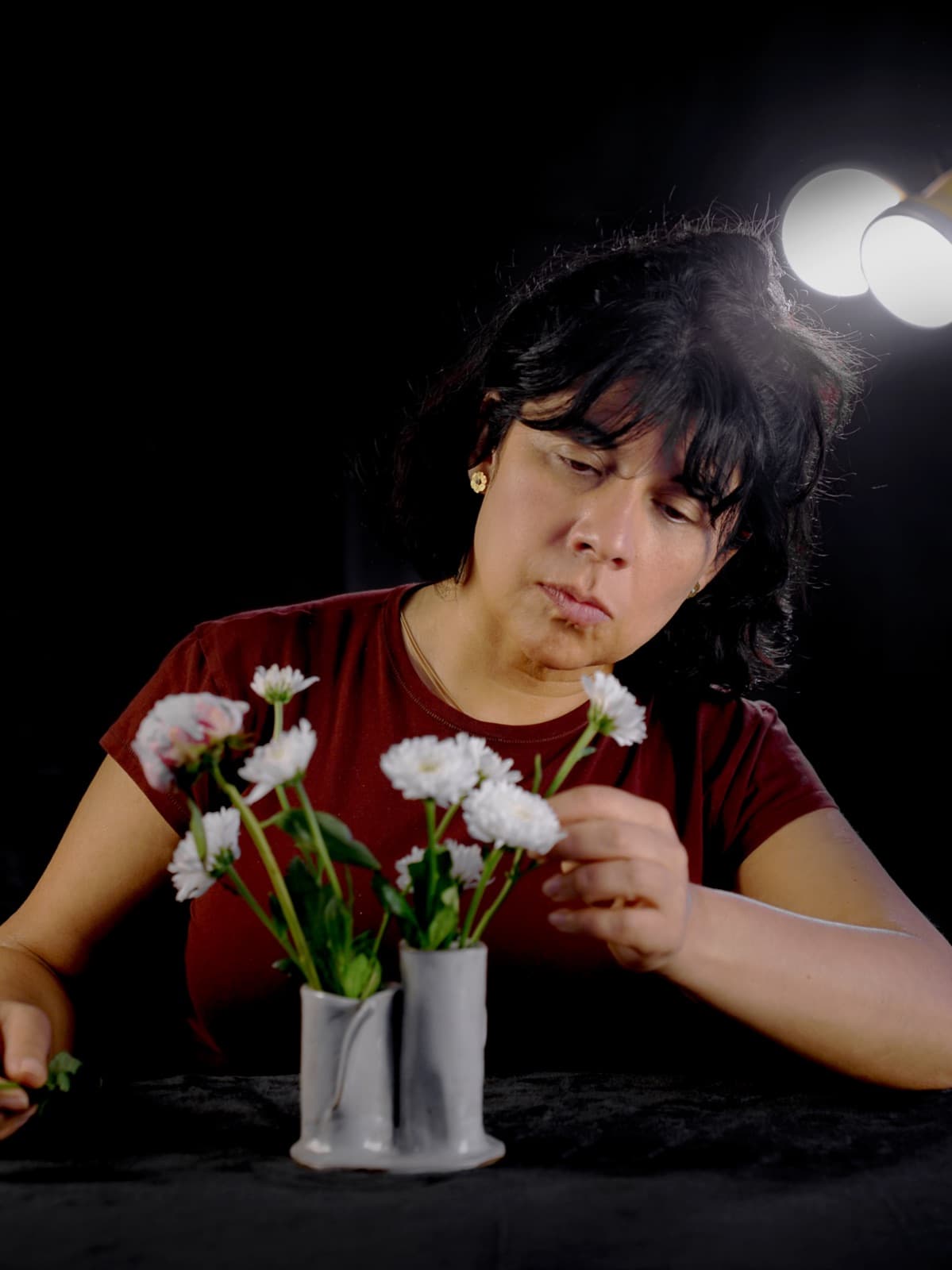 Eileen at work, arranging white flowers in her twin bud vases